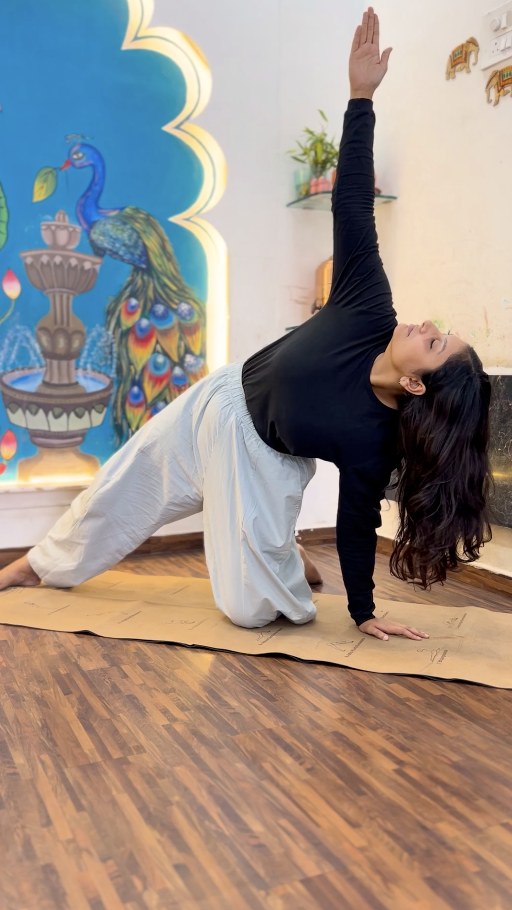 A yoga practitioner in Trikonasana (Triangle Pose) outdoors